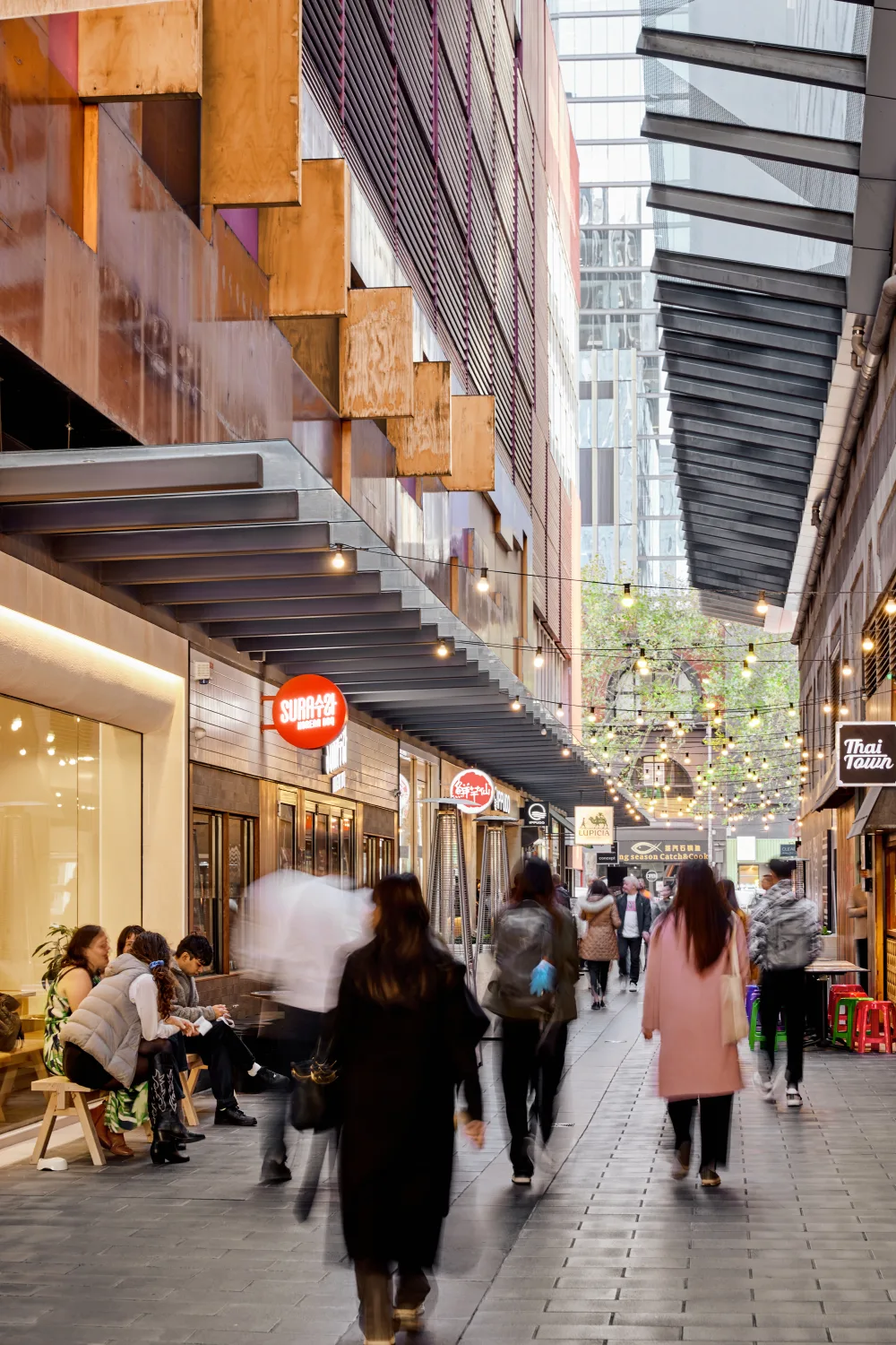 A Melbourne laneway at QV, busy with people under strings of lights